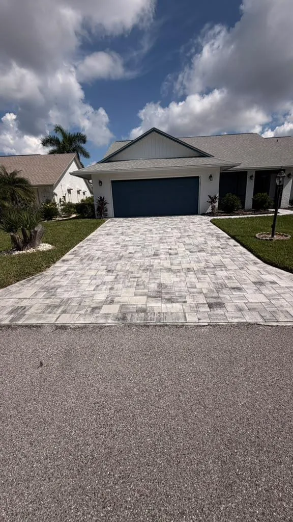 Freshly painted white stucco house with a navy garage door in Fort Myers